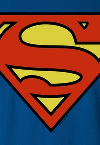 Blue fabric features a large red and yellow Superman logo, outlined in black, with a prominent stylized "S" at the center.