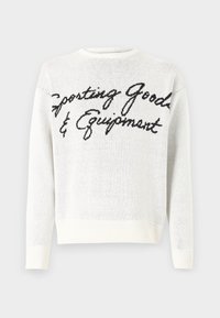 White knit sweater featuring black script text "Sporting Goods & Equipment" across the front, rounded neckline, and ribbed cuffs.