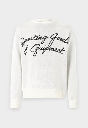 White knit sweater featuring black script text "Sporting Goods & Equipment" across the front, rounded neckline, and ribbed cuffs.