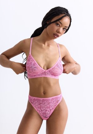 Pink lace bralette and matching thong featuring floral patterns, adjustable straps, and a soft, textured fabric design.