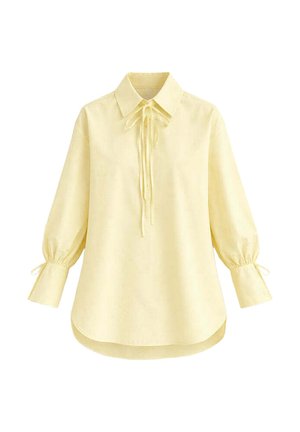 Μακρυμάνικο μπλουζάκι σε απαλό κίτρινο με μυτερό γιακά, λεπτομέρεια δεσίματος στο μπροστινό μέρος, μαζεμένα μανίκια με μικρά φιογκάκια και κυρτή στρόφιγγα.