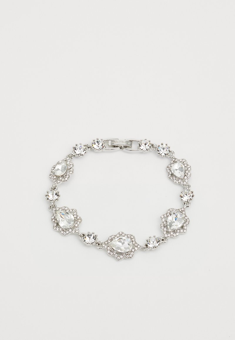 Silver-tone bracelet featuring multiple round and teardrop clear crystals set in ornate, floral-like bezels. Secure clasp closure.