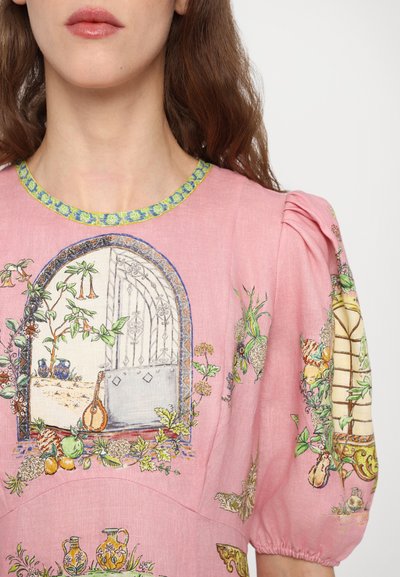 Pink linen dress featuring botanical and architectural illustrations, short puffed sleeves, and a blue and green decorative neckline.
