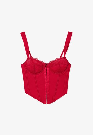 Red corset with lace trim and adjustable straps, featuring a structured shape, a front fastening, and smooth fabric texture.