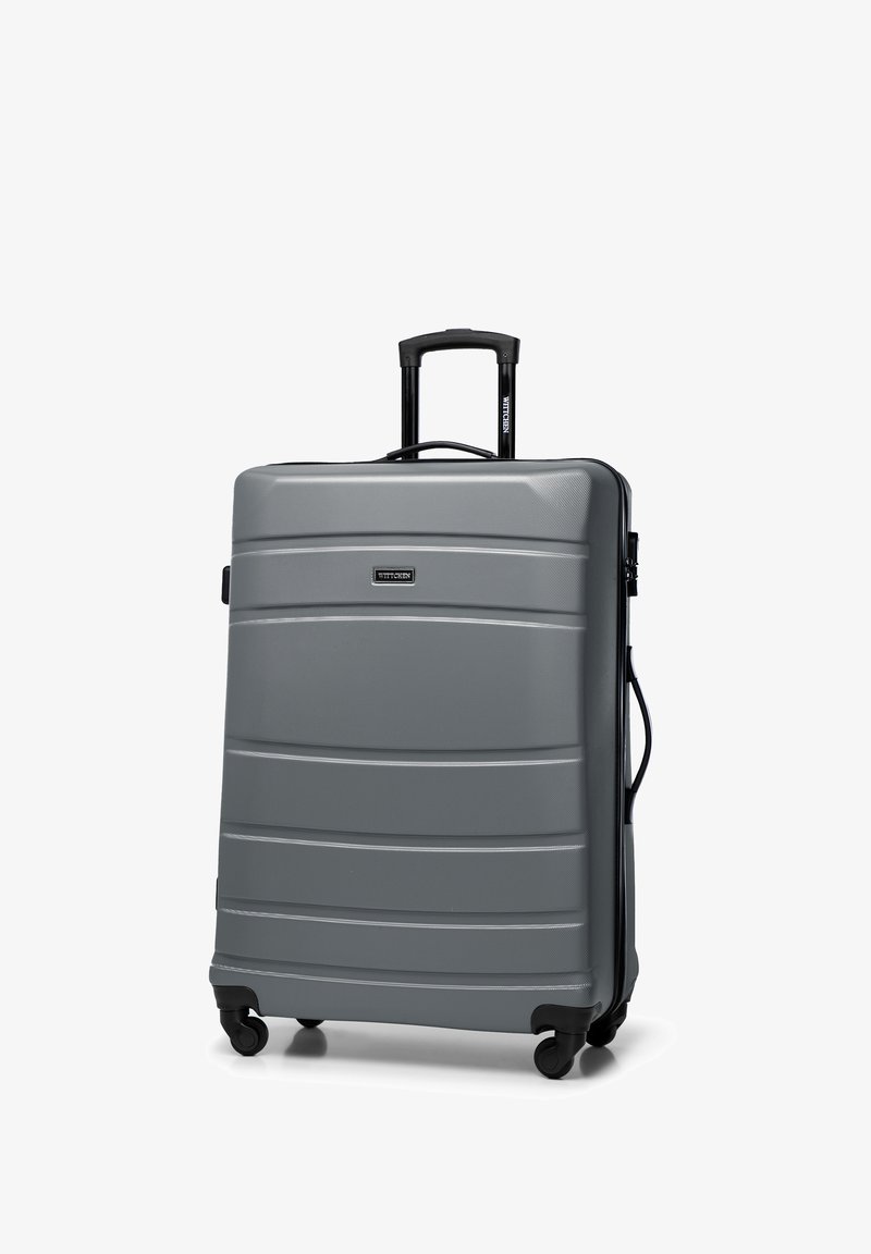 Valigia rigida con ruote in materiale grigio testurizzato, dotata di manico retrattile, manico laterale e quattro ruote scorrevoli.