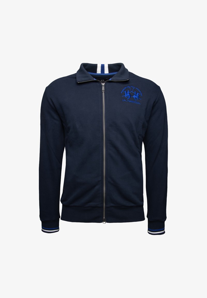 Navy blue zip-up jacket in soft fabric, featuring a raised collar, white-striped accents, and an embroidered logo in blue on the chest.