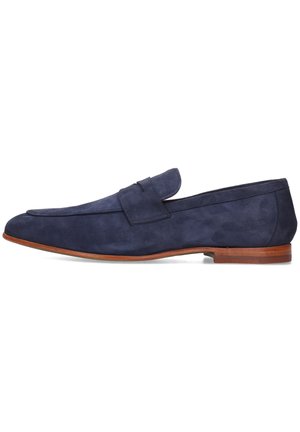 Mocasines de ante azul marino con punta ligeramente afilada, suela flexible y un panel superior distintivo con costura. Textura suave con acentos mínimos.
