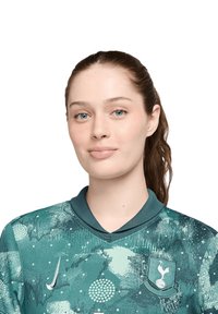 Maglia da calcio Nike in teal con un motivo testurizzato, colletto corto ed emblema sul lato sinistro del petto. Tessuto liscio con grafiche vivaci.