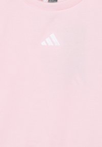 Pink sweatshirt with a round neckline and ribbed edges. Features a small white logo of three stripes on the left chest area. Soft texture.