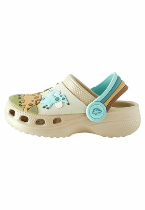 Beiger Kinderclog mit Dinosaurierverzierungen und verstellbarem Fersenriemen in Pastellblau, Grün und Braun.