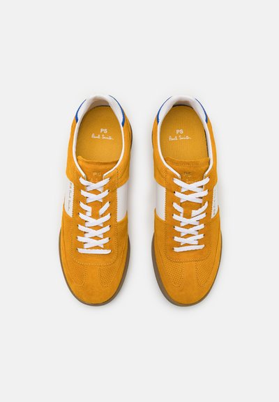 Orange suede sneakers with white leather accents, textured uppers, white laces, and a gum rubber sole. Branding visible inside.