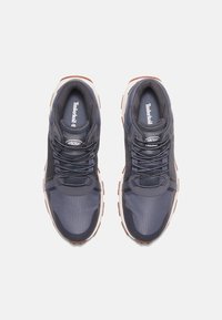 Scarpe sportive blu scuro con tomaia in rete e tessuto, punta arrotondata, suola imbottita e suola in gomma marrone chiaro a contrasto.