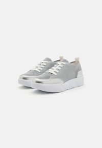 Metallic silver and gray sneaker with mesh upper, white laces, and a textured platform sole. Features a looped heel tab for easy wear.