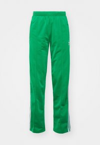 Pantalones de chándal verdes hechos de una tela suave, con un diseño de pierna recta, cintura elástica y rayas laterales blancas con un logotipo en la parte frontal.