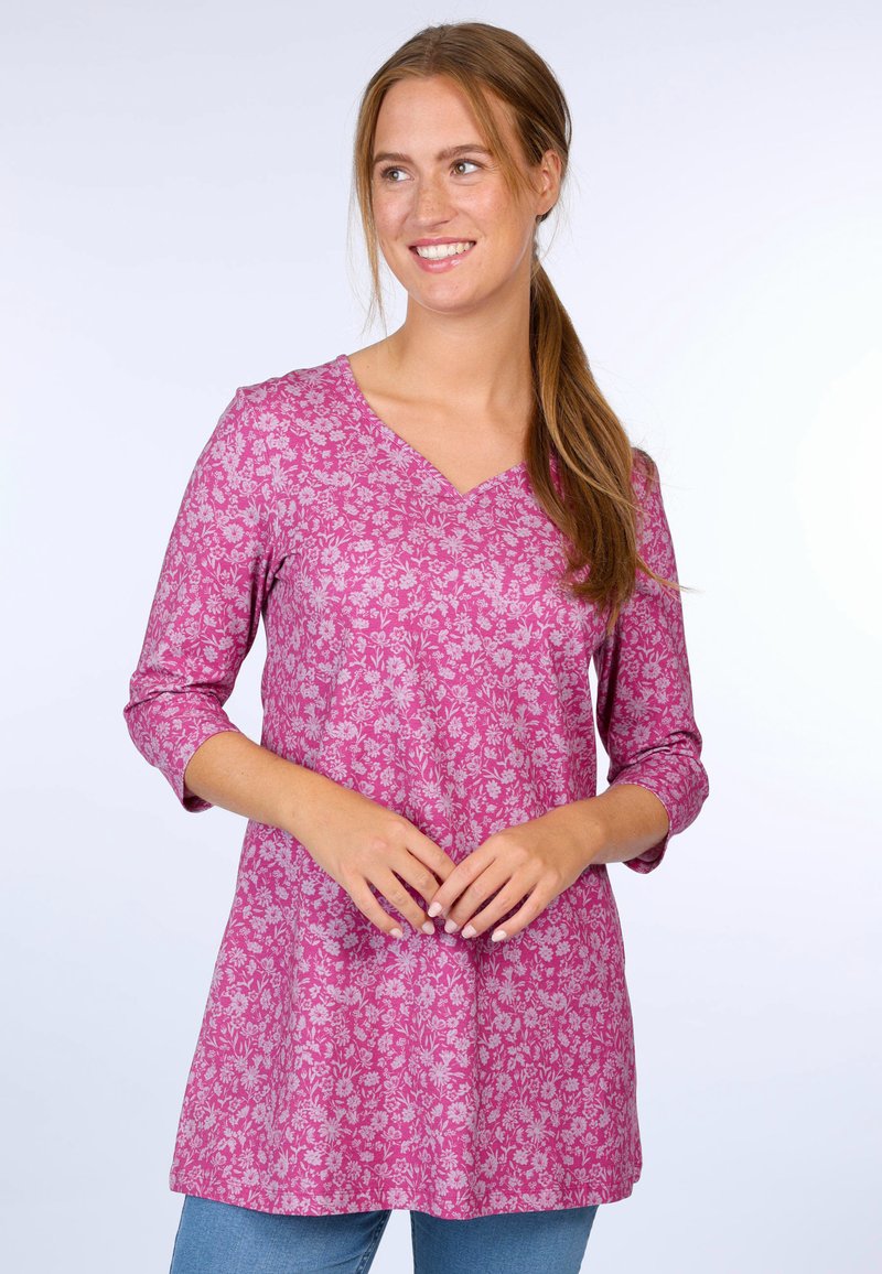 Pink floral tunic top with 3/4 sleeves, V-neckline, and a loose fit, featuring a delicate repeating flower pattern on soft fabric.