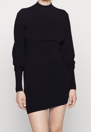 Robe en tricot noire avec un col haut, des manches longues bouffantes et une silhouette ajustée, ornée de poignets côtelés et d'une longueur mini.