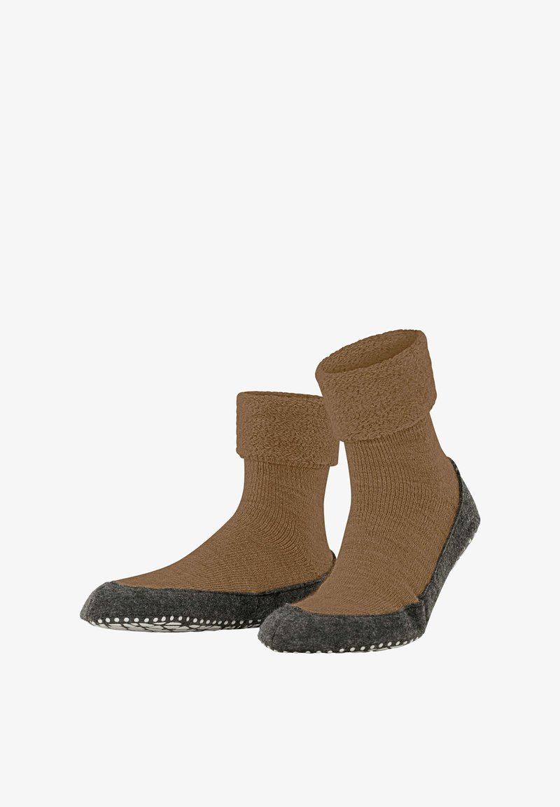 Brązowe wełniane skarpetki z teksturowanym, złożonym mankietem i ciemnoszarymi, filcowymi podeszwami z małymi białymi kropkami wzdłuż krawędzi.