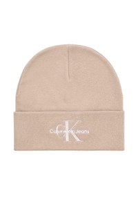 Beżowa dzianinowa czapka z podwiniętym mankietem. Ozdobiona białym wyszywanym logo „CK” oraz napisem „Calvin Klein Jeans”, wykonana z miękkiego, fakturowanego materiału.