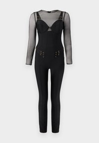 Μαύρη εφαρμοστή ολόσωμη φόρμα με διάφανα μακριά μανίκια, πάνω μέρος σε στυλ κορσέ με δομημένη φόρμα και χρυσές αγκράφες στις τιράντες και τους γοφούς.