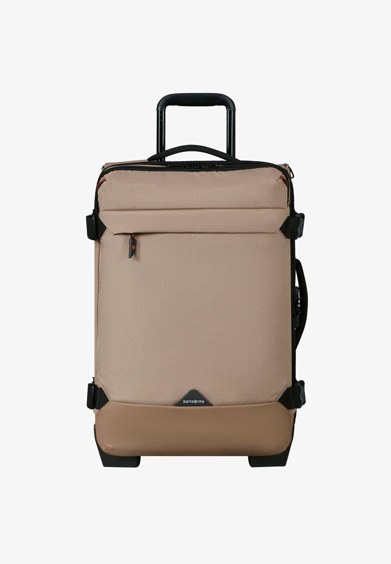 Light beige wheeled suitcase with a textured surface, zippered front pocket, and black accents. Features a retractable handle and durable wheels.