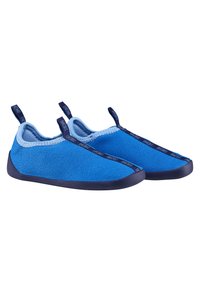 Blue slip-on shoes with a textured upper, contrast stitching, and a dark blue rubber sole. Two looped pull tabs on the back for easy wear.