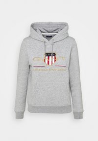 Felpa grigia chiara con cappuccio, tasca anteriore, lacci e logo ricamato con scudo, testo "GANT," "1949," e "American Sportswear."