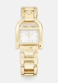 Goldfarbene rechteckige Armbanduhr mit poliertem Metallarmband, weißem Zifferblatt und schwarzen Stundenmarkierungen; verfügt über ein charakteristisches Fossil-Logo.