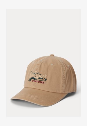 Beige baseball cap with stitched logo reading "Polo Sport" above green tree line and "SPORTSMAN" in red below.