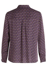 Long-sleeve blouse in purple fabric with a geometric pattern in cream and brown. Features a collar and buttoned cuffs. Smooth texture.