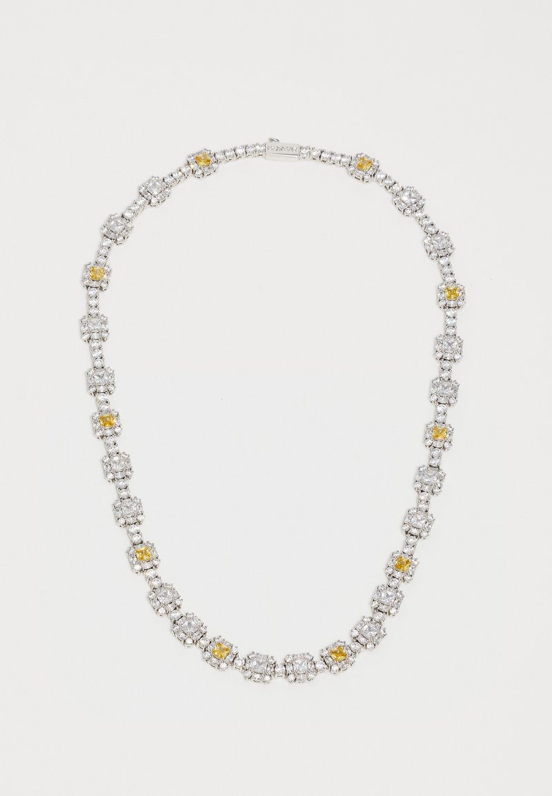 Silver necklace with alternating clusters of clear and yellow gemstones arranged in a repeating pattern on a plain background.