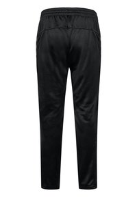 Schwarze Sporthose mit elastischem Bund, geraden Beinen und dezenten seitlichen Details, von hinten auf weißem Hintergrund gezeigt.