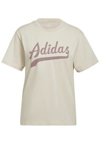 Kreminės spalvos medvilnės marškinėliai trumpomis rankovėmis su rožinės spalvos „Adidas“ logotipu, rašytu kursyvu, ant priekinės dalies. Lygus audinys, laisvas kirpimas.