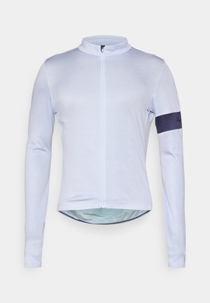 Light blue long-sleeve cycling jersey with a high collar, full zip, and navy accent on the left sleeve. Made from a smooth, lightweight fabric.