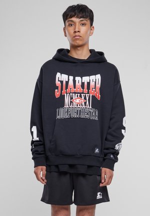 Black hoodie with white and red "STARTER" graphic on the front, kangaroo pocket, and long sleeves with print; paired with black mesh shorts.