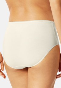 High-waisted, light beige cotton briefs with a smooth texture, featuring a seamless waistband and minimal stitching details.