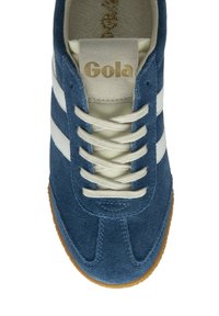 Blue suede athletic shoe with white stripes and cream laces. Features a tan rubber sole and a gold logo on the tongue.