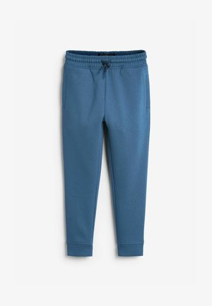 Modré bavlnené jogger nohavice s elastickým pásom, detailom na šnúrku a dvoma bočnými vreckami. Lemy na členkoch. Hladká textúra.