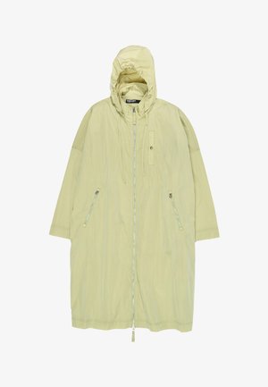 Długi jasnobeżowy płaszcz z kapturem, z przednim zamkiem błyskawicznym, dwoma bocznymi kieszeniami na zamek oraz regulowanymi sznurkami kaptura.