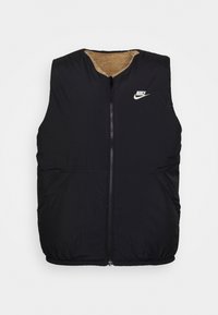 Svart pufferväst med dragkedja fram, rundad halsringning och beige fleecefoder. Har en liten vit Nike-logotyp på bröstet och sidofickor.