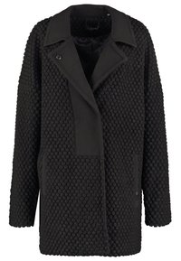 Abrigo negro texturizado con un destacado patrón acolchado, gran cuello y bolsillos delanteros. Fabricado con una mezcla de tejidos y un ajuste holgado.