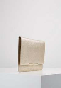 Metallic gold clutch bag with a textured surface, rectangular shape, and a small clasp closure. Features a sleek, minimalist design.