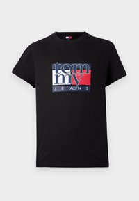 T-shirt en coton noir avec un logo graphique en bleu, rouge et blanc. Manches courtes et design col rond.
