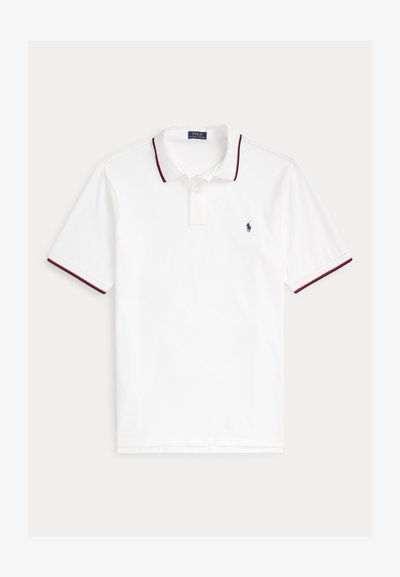 Tricou polo alb cu mânecă scurtă, cu bordură bleumarin și roșie la guler și mâneci, cu două nasturi la guler și logo mic brodat bleumarin pe piept.