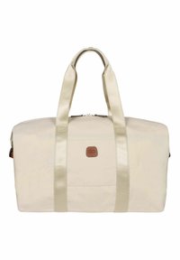 Borsa duffle beige con manici color crema, dotata di un patch con logo sulla parte anteriore, chiusura con zip e una texture in tessuto liscia e resistente.