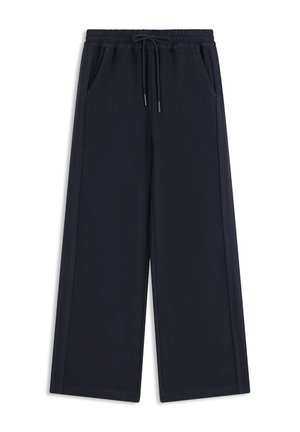 Pantalon large noir avec taille élastique, cordon de serrage et poches latérales, fabriqué dans un tissu doux et texturé.