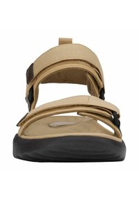 Beżowe sandały z regulowanymi paskami z tkaniny, czarna gumowa podeszwa i wyściełana wkładka. Posiadają przedni pasek z pętlą ułatwiającą zakładanie.