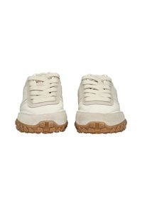 Ein Paar beige und cremefarbene Sneakers mit strukturierten braunen Gummisohlen, von vorne auf einem weißen Hintergrund betrachtet.