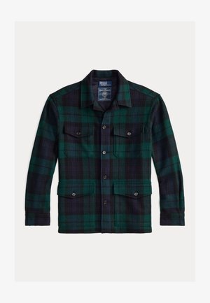 Tamsiai žalia ir jūros mėlynumo flanelinė vilnos striukė su langeliais. Yra smailas apykaklė, dvi priekinės kišenės su mygtukų uždarymu ir tiesus apvadas.