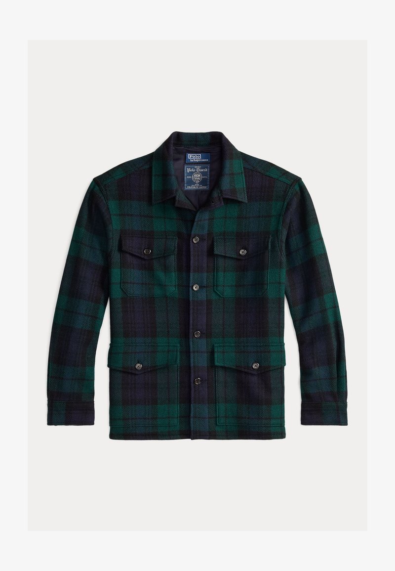 Uldflanneljakke i mørkegrøn og marineblå plaid. Har en spids krave, to forlommer med knaplukninger og en lige nederste kant.