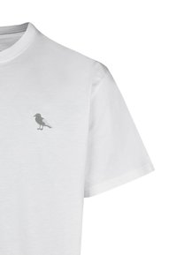 Weißes Kurzarm-T-Shirt aus Baumwolle mit einem kleinen grauen Vogel, der auf der linken Brustseite gestickt ist. Weiche Textur, klassischer Schnitt.